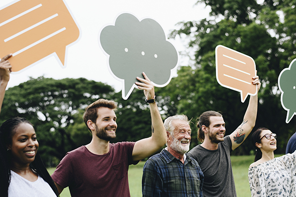 Happy diverse people holding colorful speech bubbles